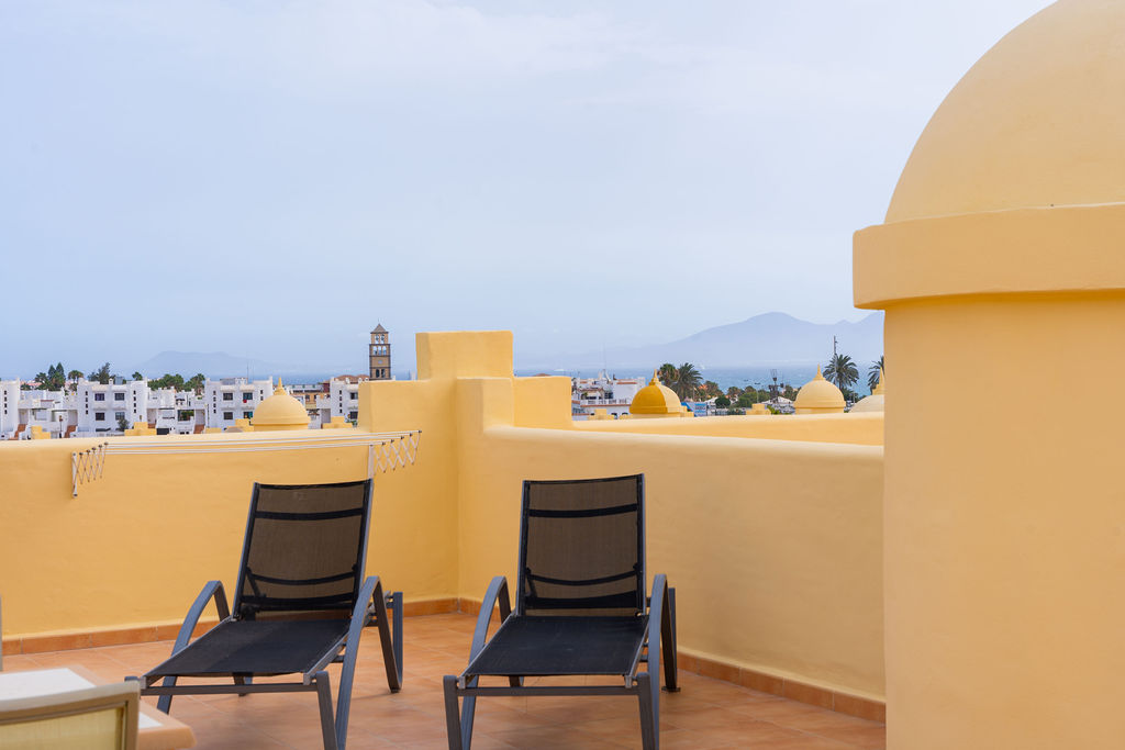 Terraza privada con tumbonas en Apartamentos y Villas El Sultán